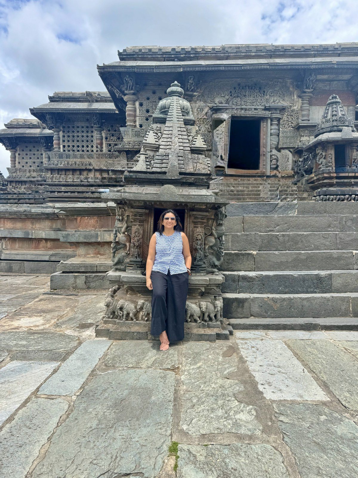 Rashmi standing in the doorway of a carved Hoysala temple in India